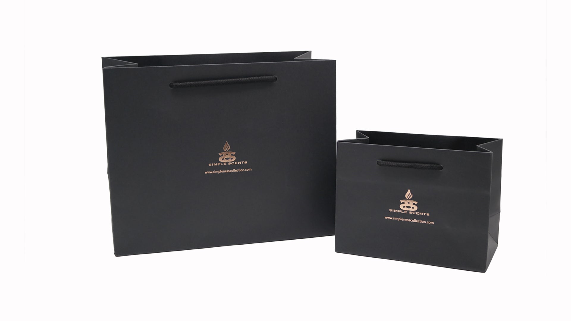 One Medium and One Large black gift bags with Simple Scents logo on the front.