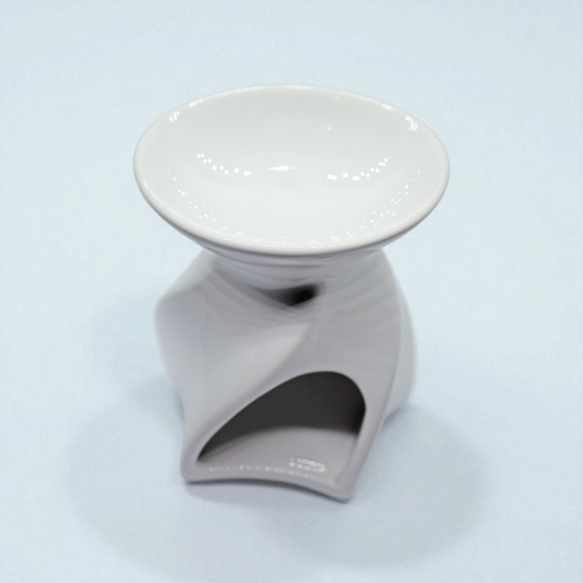 Lyon Ceramic Tea Light Wax Burner - white twisted spiral Lyon ceramic wax burner with empty white dish on light blue background