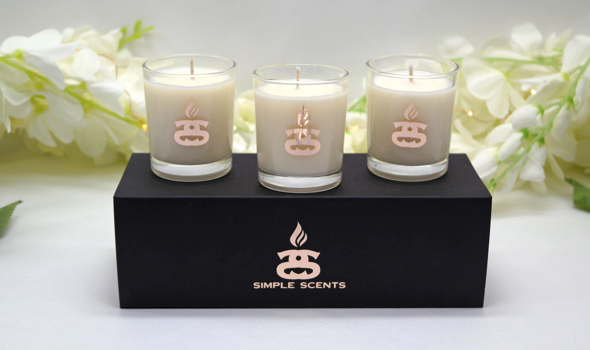 Simple Scents Mini Indulgence Trio Luxury Soy Candles 75g - three cream soy wax votive candles on black gift box with white floral backdrop