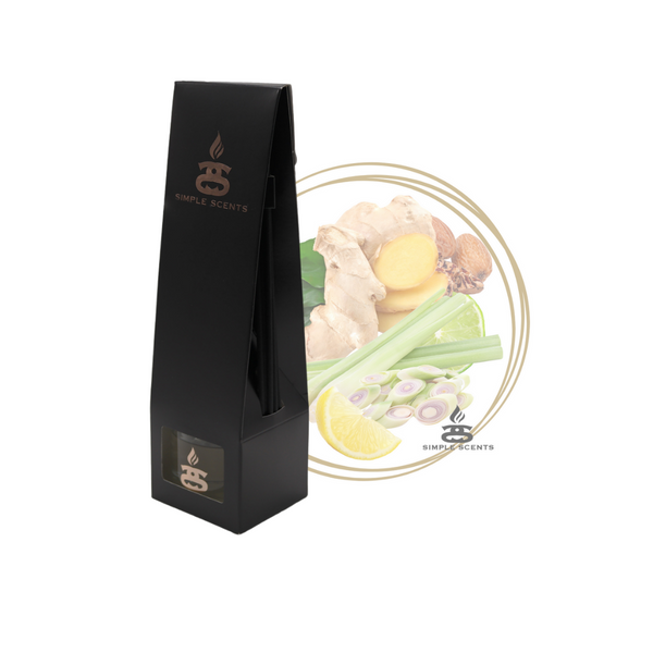 Lemongrass and Ginger Simple Scents Excellence Reed Diffuser - matte black tall tapered packaging box with rose gold Simple Scents logo, displayed in front of lemongrass stalks, fresh ginger root and lemon slices inside a gold double-ring circle frame on white background