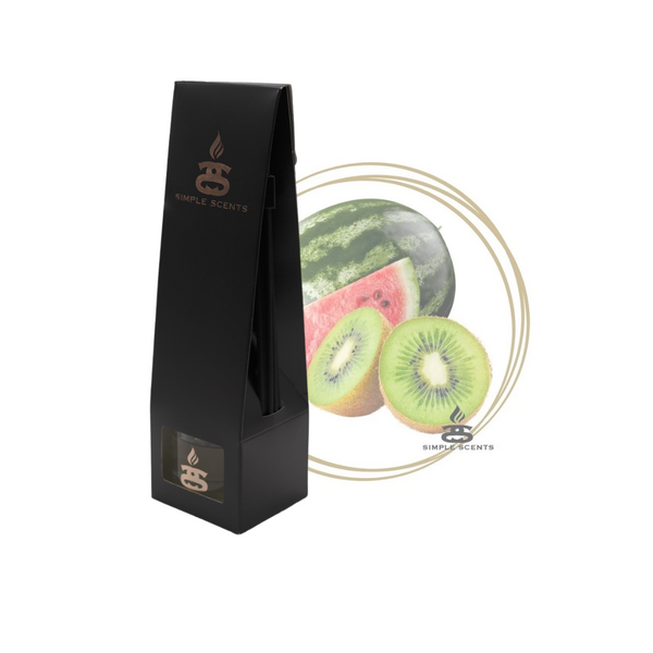 Watermelon and Kiwi Simple Scents Excellence Reed Diffuser - matte black tall tapered packaging box with rose gold Simple Scents logo, displayed in front of a watermelon slice and halved kiwi fruit inside a gold double-ring circle frame on white background