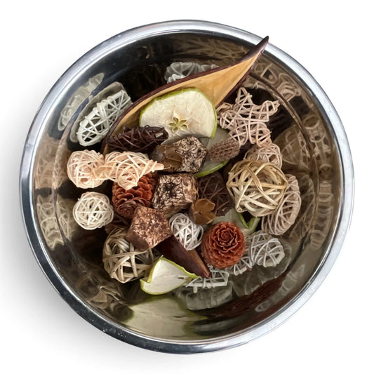 Midnight Fjord Woods Boujee Potpourri displayed in a silver bowl, featuring dried pinecones, wicker balls, seed pods, dried apple slices and aromatic botanics