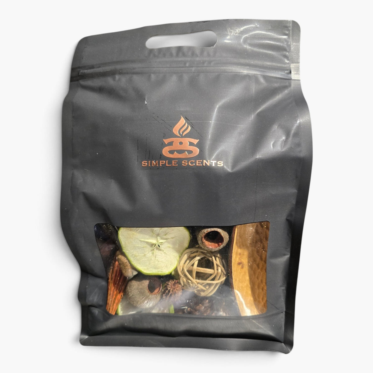 A black resealable stand-up pouch with a clear window showing dried botanical ingredients inside, branded Simple Scents on the front, photographed against a plain white background.