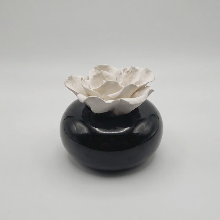 Simple Scents Modern Rose aroma stone diffuser with a sculpted white flower and glossy black ceramic base.