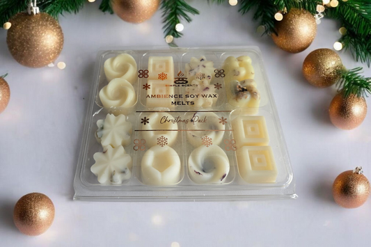 Pack of Christmas-themed soy wax melts with decorative gold ornaments and greenery.