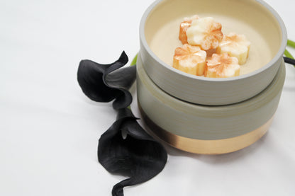 Grey & Rose Gold Electric Ceramic Wax Melter & Candle Warmer with wax melts next to black lillies